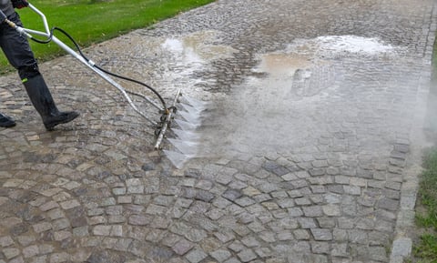 Cleaning cobblestone pavement with pressure washer